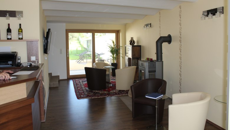 Guesthouse Woditschka, © Fam. Woditschka Interior view of a modern guest house with seating area, fireplace and glass door to the garden.