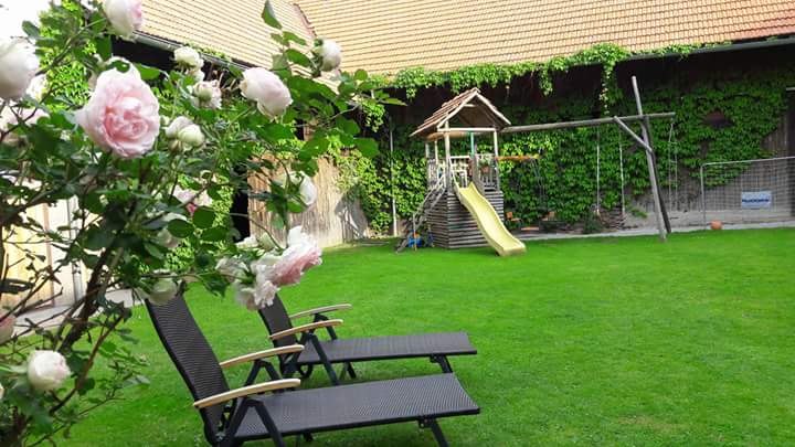 A view of the inner courtyard, © rosinge Inner courtyard with lawn, two sun loungers, rose bush and playground with slide.