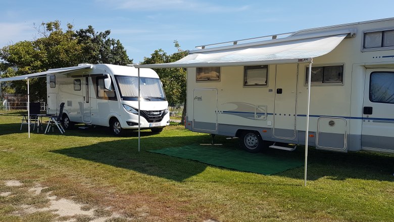Camping, © Fam. Kruspel Two motorhomes with extended awnings on a campsite.