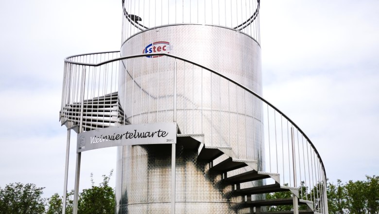 A wine tank as a lookout point, © Weinstraße Weinviertel Metal viewing platform with spiral staircase outside.