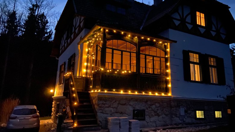Orlet on the Rax, © Sofia Orlet An illuminated house decorated with fairy lights at dusk.