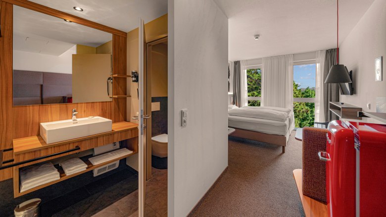 Zündwerk Motel, © Propertyphotos / Lukas Drobny Interior view of a modern hotel room with bathroom, bed and red fridge.