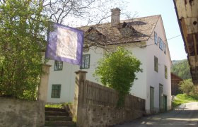 Wittgenstein Museum, © Gemeinde Trattenbach A white building with green window frames and a sign saying 'Trattenbach'.