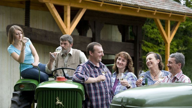 The Wiesinger family, © Michael Himml Group of people on a farm drinking wine.