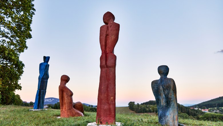 Good gas part, © Nina Nagy Photography Four colorful sculptures on a meadow at sunset.