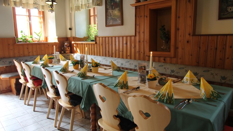 Restaurant, © Gasthof Eschau Cozy dining room with set table, wooden chairs and decoration.