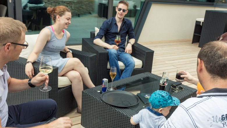 Socializing on the terrace, © KASTNER NEW MEDIA - kastner.tv Group of people sitting on a terrace drinking drinks.