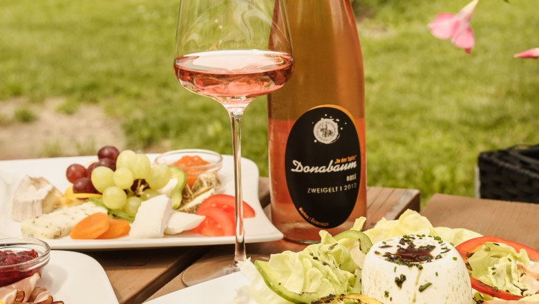 Snack at the Strawanzer, © Rita Newman A table set outside with wine, salad and cheese platter at the Strawanzer wine tavern