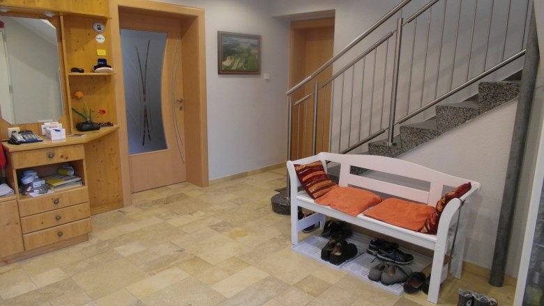 Lugerhof entrance area, © Lugerhof Entrance area with wooden chest of drawers, bench with cushions and stairs.