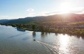 ahoi-wachau aerial view, © NÖW_Daniel Gollner Aerial view of the Wachau with river, boats and village at sunset.