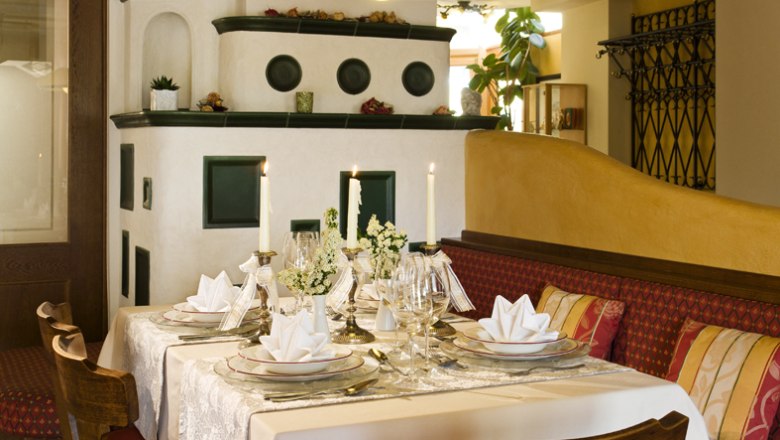 to the beautiful Viennese, © Engel Elegant restaurant with laid table and candles.