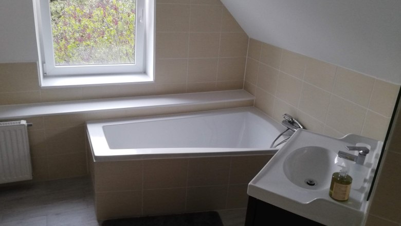 Bathroom, © Günter Lammer Modern bathroom with bathtub, washbasin and window.