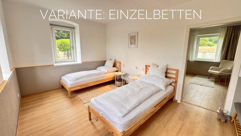 Bedroom, © Christoph Menhofer Bedroom with two single beds, wooden floor and window with view to the outside.