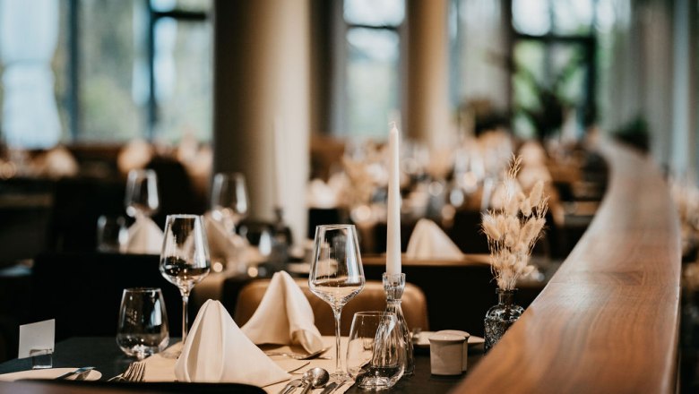 Restaurant in the hotel at Therme Laa, © Victor Liska Elegant restaurant with laid table, wine glasses and candles.