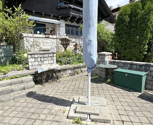 Seat at the house Anton, © Haus Anton Paved seating area in the garden with parasol and barbecue facilities