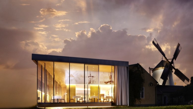 Windmühlheuriger Bergmann, © Alexander Schleissing Modern glass architecture next to a traditional windmill at sunset.