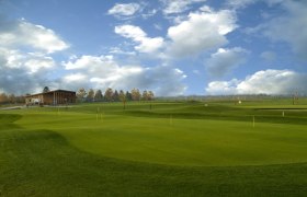 Guntramsdorf Golf Club, © C. Steiner Golf course with clubhouse and cloudy sky.