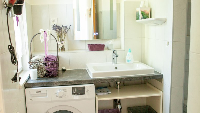 Bathroom, © Michael Sokolar Modern bathroom with washing machine, washbasin and mirror.