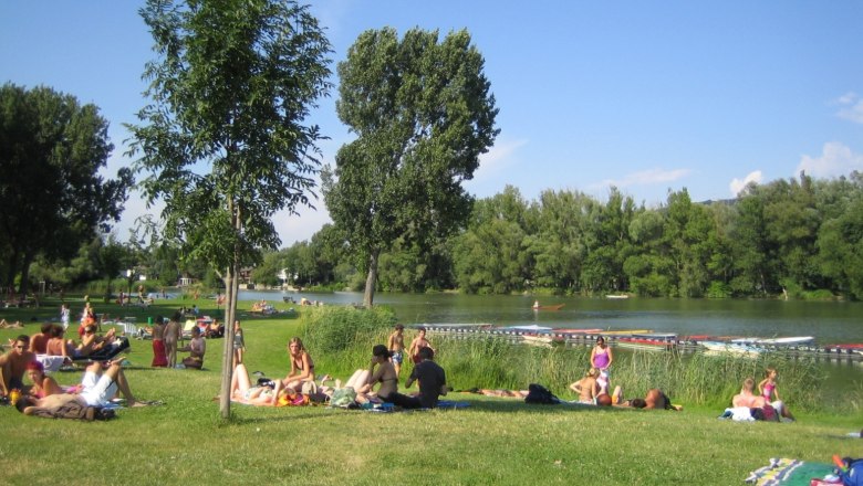 ...and our sunbathing lawn!, © strandbad People relaxing on a meadow on the riverbank in sunny weather.
