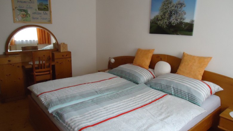 bedroom_22, © Karl Temper Cozy bedroom with double bed, wooden furniture and murals.