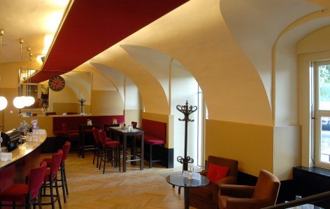 Cafe Wachau, © Cafe Wachau Interior view of a stylish café with red chairs and vaulted ceilings.
