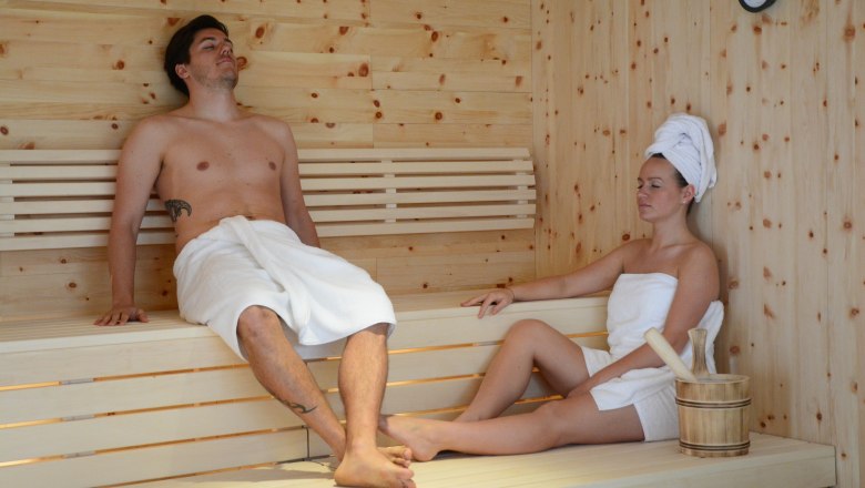DanubeSplash, © Stadtgemeinde Tulln Two people relax in a wooden sauna.