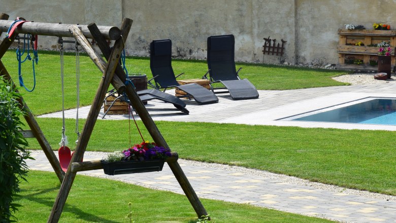 View from the balcony, © Familie Schwalm Garden with swing, sun loungers and pool.