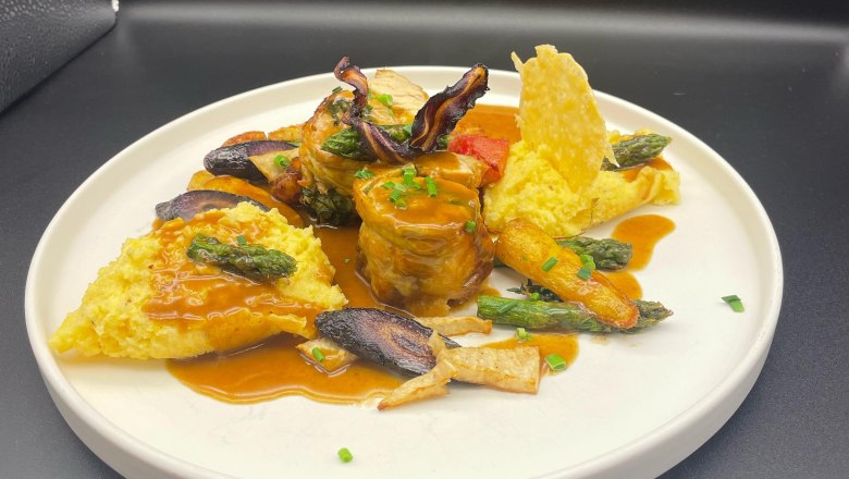 Dining at the Freiherr, © Markus Jokesz Gourmet dish on a white plate with meat, vegetables and sauce.