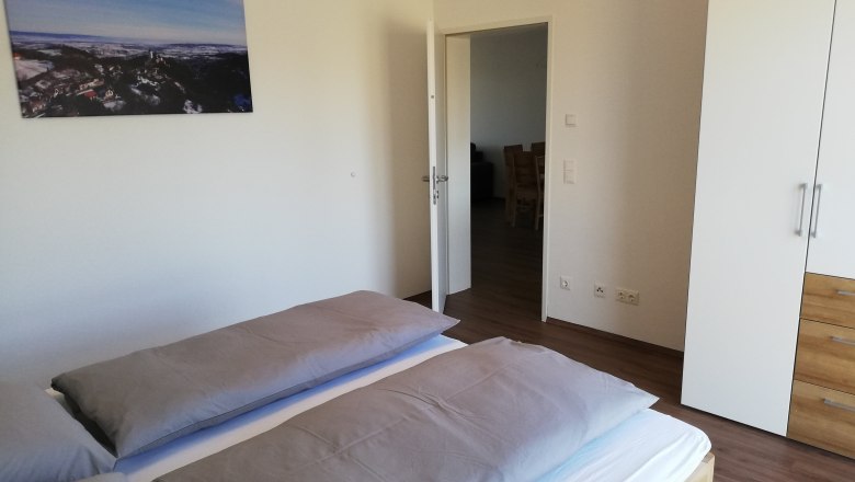 Bedroom, © Peter Hecht Modern bedroom with double bed, white closet and landscape picture on the wall.