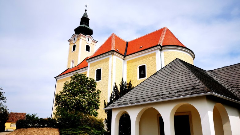 St. Nicholas parish church, © Weinstraße Weinviertel St. Nicholas parish church in Röschitz with yellow façade and red roof.
