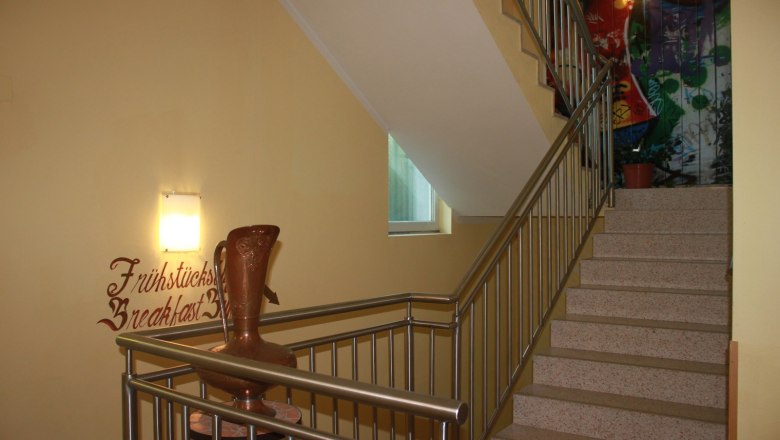 Staircase, © Nimal Poudel Staircase with banister, wall decoration and vase.