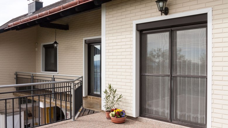 Exterior view, © Fam. Sulzbacher Exterior view of a house with balcony, railings and flower pots.