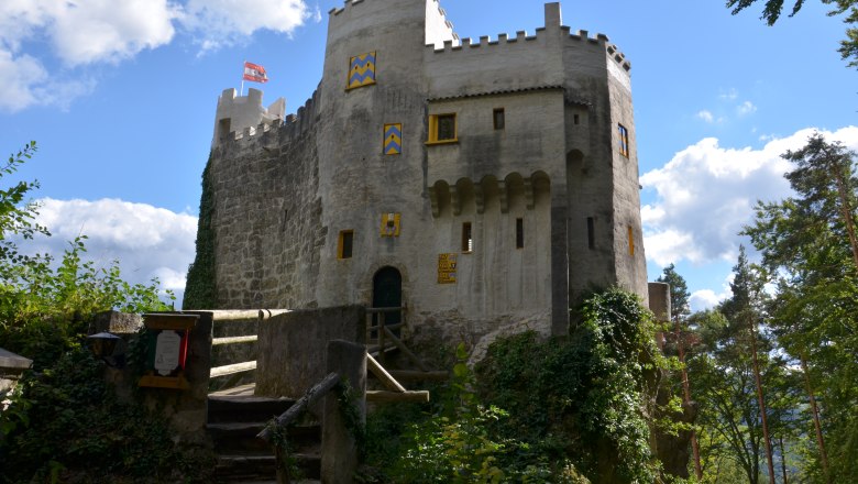 Grimmenstein Castle, © Marktgemeinde Grimmenstein Grimmenstein Castle with bridge, battlements and blue and yellow painted shutters in the countryside.