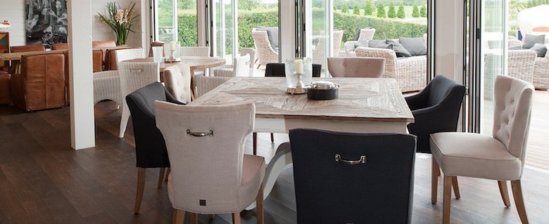 View of terrace, © Diamond Club Atzenbrugg Interior with dining table and chairs, view of terrace with seating furniture.