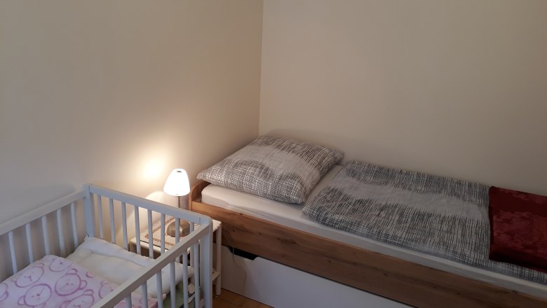 Single room, © Barbara Muck Single room with single bed, crib and bedside lamp.