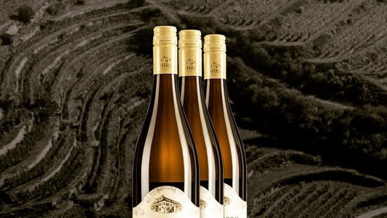 Zöhrer - The tradition lives on!, © Weingut Zöhrer Three bottles of wine against a background of vineyards.