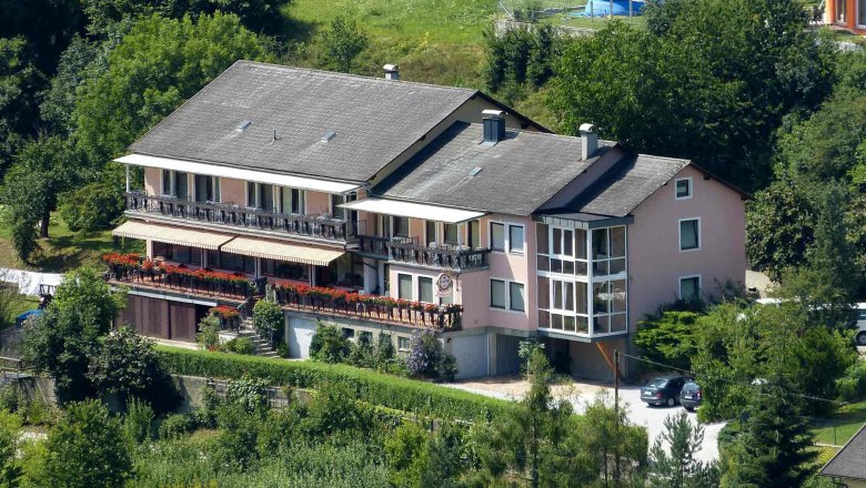 House view, © Haidn Large house with balcony and garden, surrounded by trees.