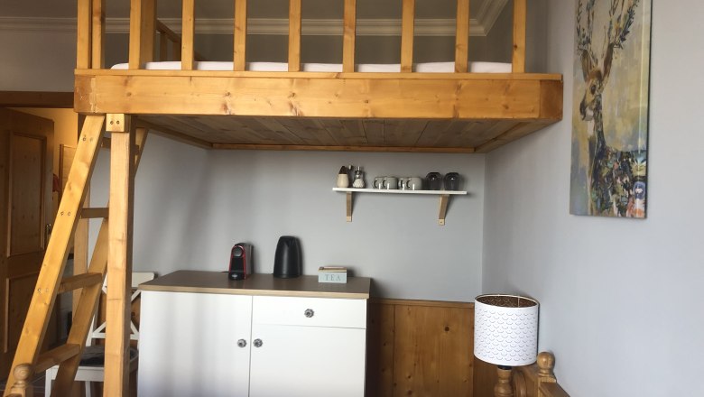 Tea corner in the room Vacation on the Jauerling, © Romana Wiener Room with loft bed, tea station and deer picture on the wall.