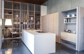 Johann_Will_05, © Waldviertel Tourismus, Robert Herbst Modern kitchen with white island, shelves and wood paneling.