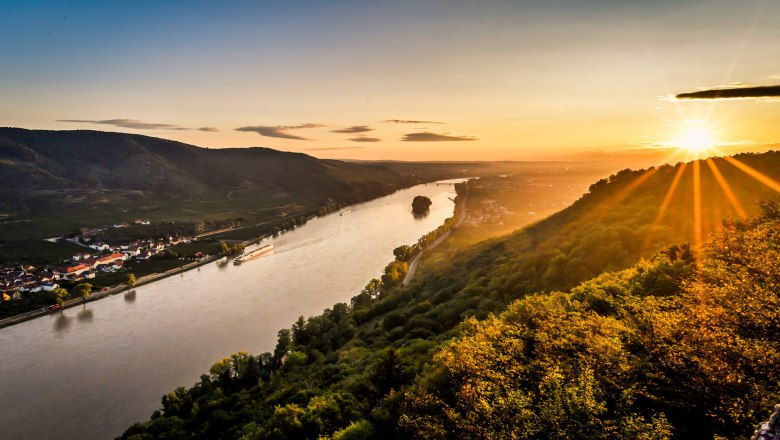 View from the Ferdinand-Warte, © Robert Herbst Sunset over a river with hills and villages in the background.