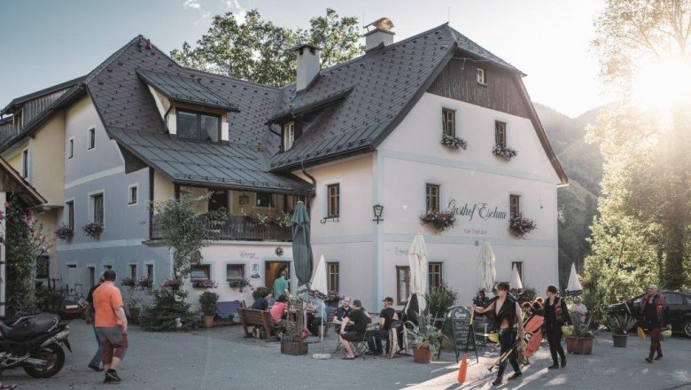 Eschau Inn, © Gasthof Eschau A traditional inn with people outside in the sunshine.