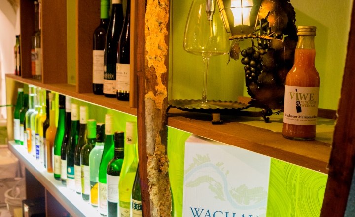 View wine bar, © Viwe Vinothek und Weinbar Shelf with wine bottles and decoration in a wine bar.