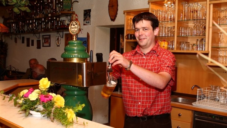 Gasthof Renner, © Marktgemeinde Ottenschlag A man draws beer at a bar in an inn.