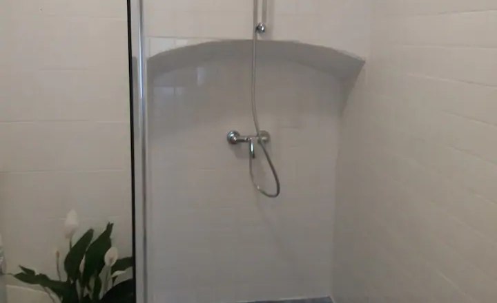 Bathroom view, © Fam. Obernberger Modern shower with blue tiles and white walls.