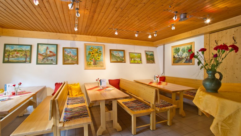 Wine tavern inside, © Rita Newman Interior view of a wine tavern with wooden furniture and paintings on the wall.