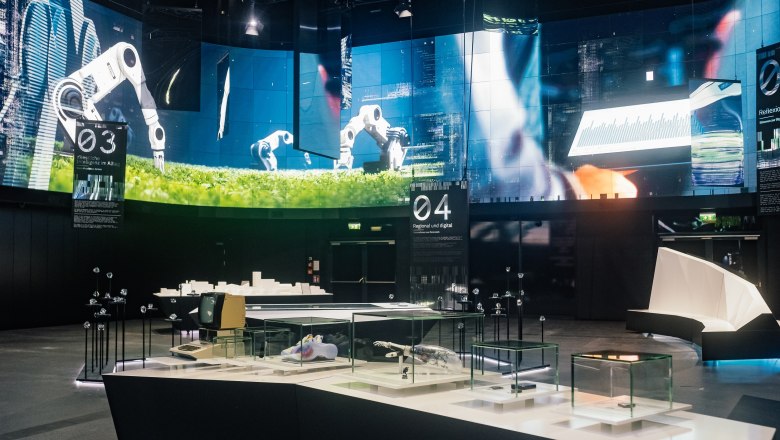 TD House of Digitization, © Leonardo Ramirez Large flatscreen on the wall with exhibition table in the foreground