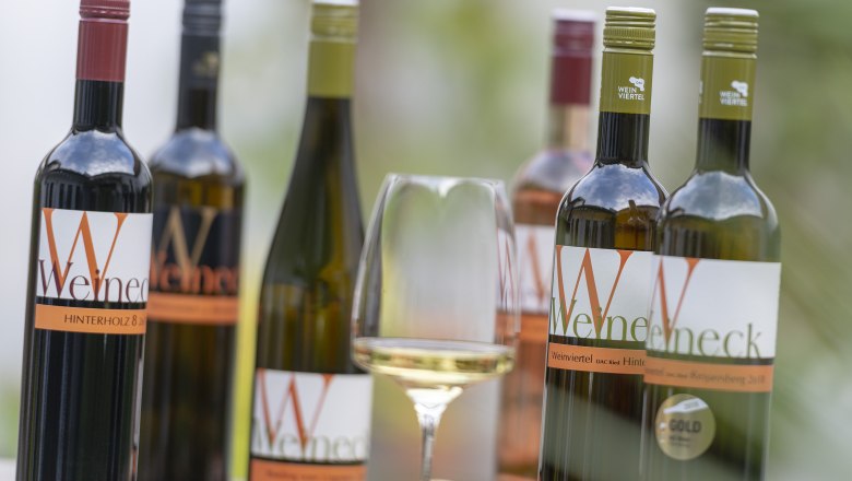 Wide range of wines, © Michael Himml Various bottles of wine and a glass of white wine on a table.