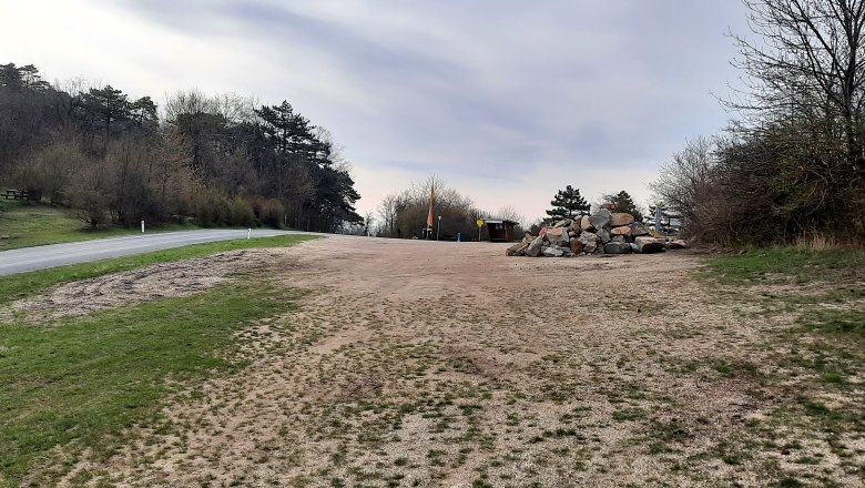 Motorhome parking space, © Bernhard Zechner Empty motorhome site with trees and road.
