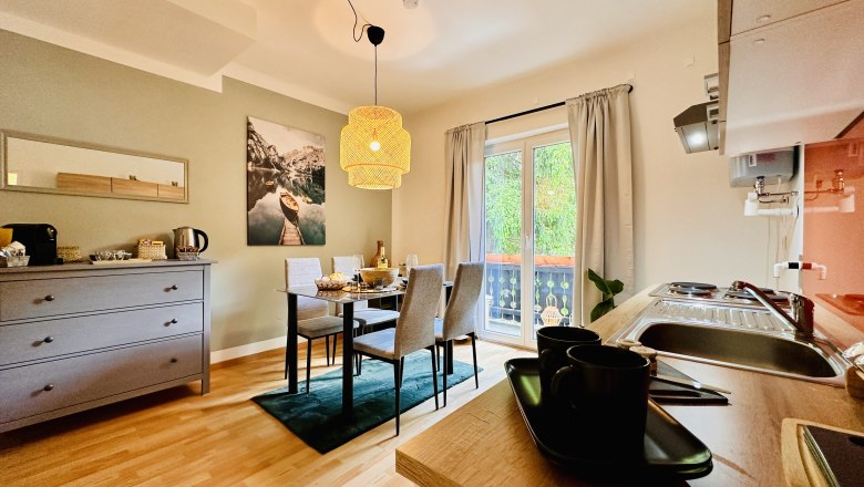 Cozy apartment with dining table, kitchenette and balcony.