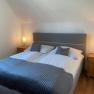 Comfortable bedroom with double bed, two bedside tables and lamps.